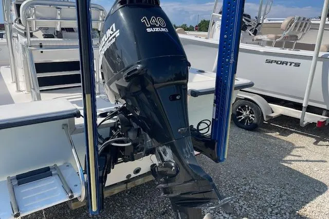 Slide: The Image of 2007 KenCraft 2260 BAYRIDER with Suzuki 140 outboard motor, parked on gravel. - 2