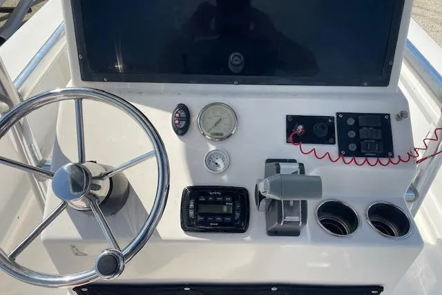 Slide: The Image of 2007 KenCraft 2260 BAYRIDER boat dashboard with steering wheel and controls. - 6