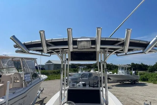 Slide: The Image of 2007 KenCraft 2260 BAYRIDER boat with T-top and rod holders, parked outdoors. - 7