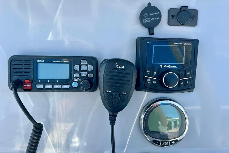 Slide: The Image of 2023 Trophy T24CC dashboard with Icom VHF radio and Rockford Fosgate audio system. - 15