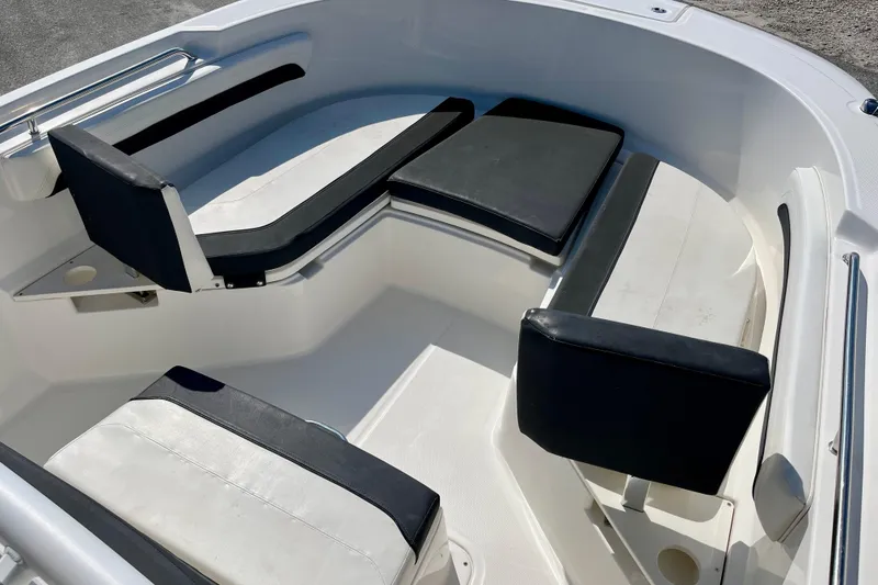 Slide: The Image of 2023 Trophy T24CC boat interior with cushioned seating and sleek design. - 16