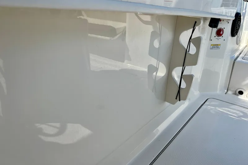 Slide: The Image of 2023 Trophy T24CC boat interior with rod holder and safety features. - 17