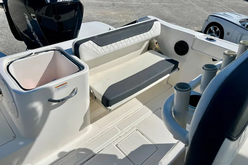 Slide: The Image of 2023 Trophy T24CC boat interior with seating, storage, and rod holders. - 19