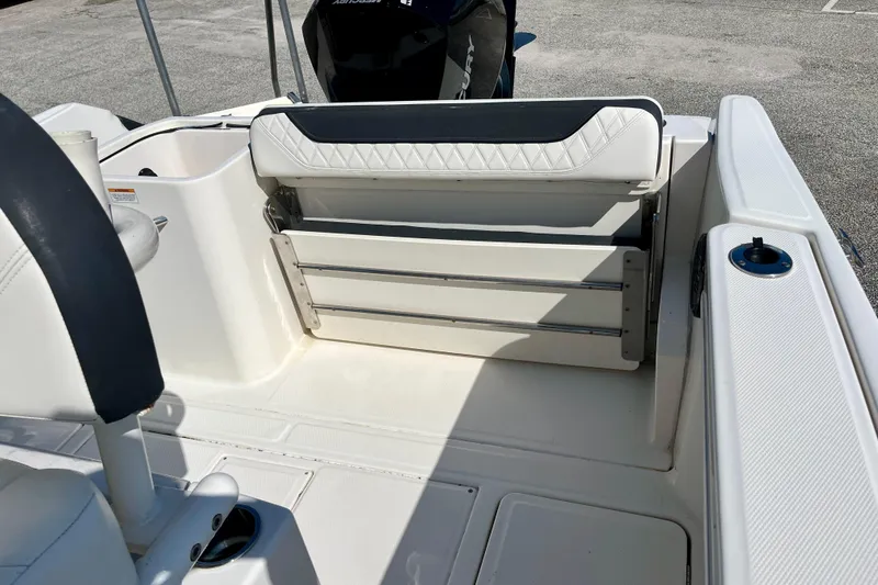 Slide: The Image of 2023 Trophy T24CC boat interior with foldable seating and storage. - 20