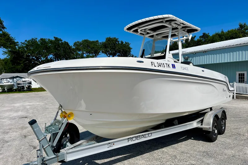 Slide: The Image of 2023 Trophy T24CC boat on trailer, parked outdoors under clear blue sky. - 3