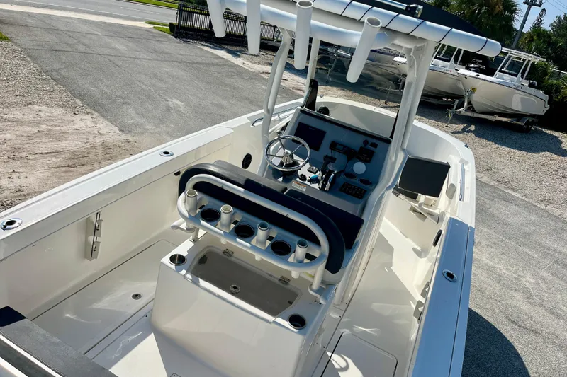 Slide: The Image of 2023 Trophy T24CC boat interior with steering console and rod holders. - 8