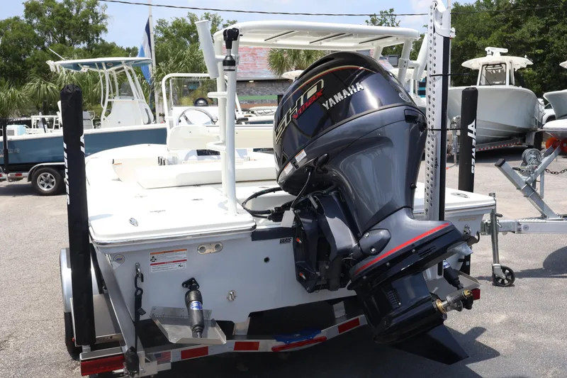 Slide: The Image of 2025 Hewes Redfisher 18 boat with Yamaha outboard motor, parked on a trailer. - 12
