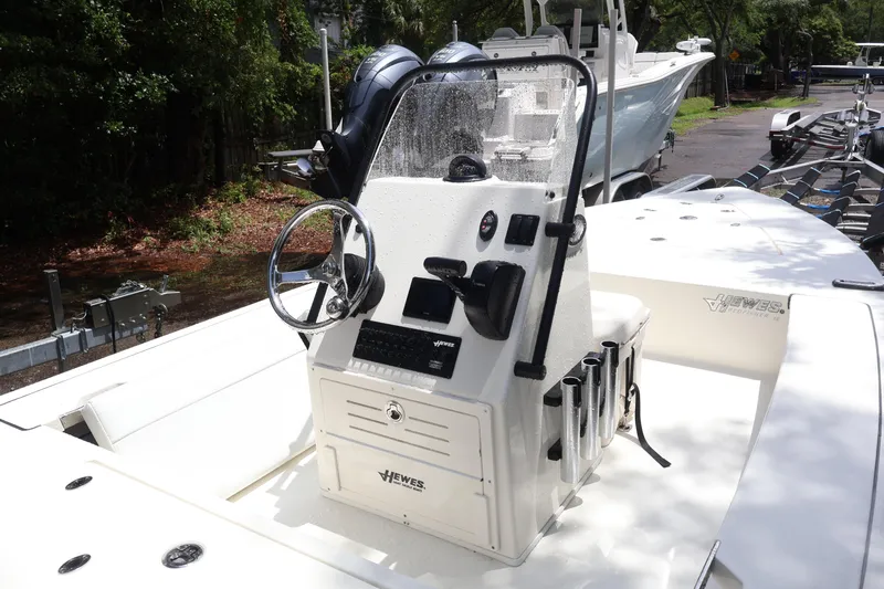 Slide: The Image of 2025 Hewes Redfisher 18 boat console with steering wheel and controls. - 3