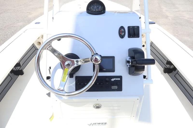 Slide: The Image of 2025 Hewes Redfisher 18 boat console with steering wheel and controls. - 4