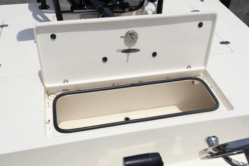 Slide: The Image of 2025 Hewes Redfisher 18 boat storage compartment open, showcasing interior space. - 8