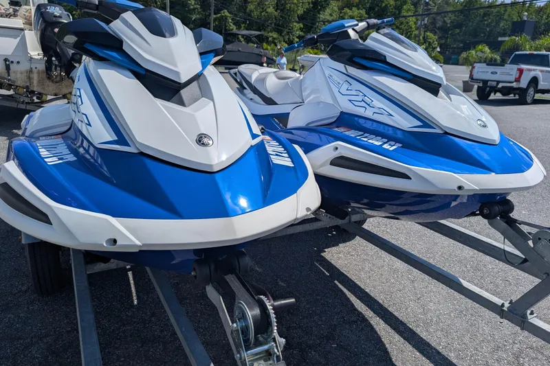 Slide: The Image of 2021 Yamaha WaveRunner VX Deluxe jet skis on trailers, parked outdoors. - 3