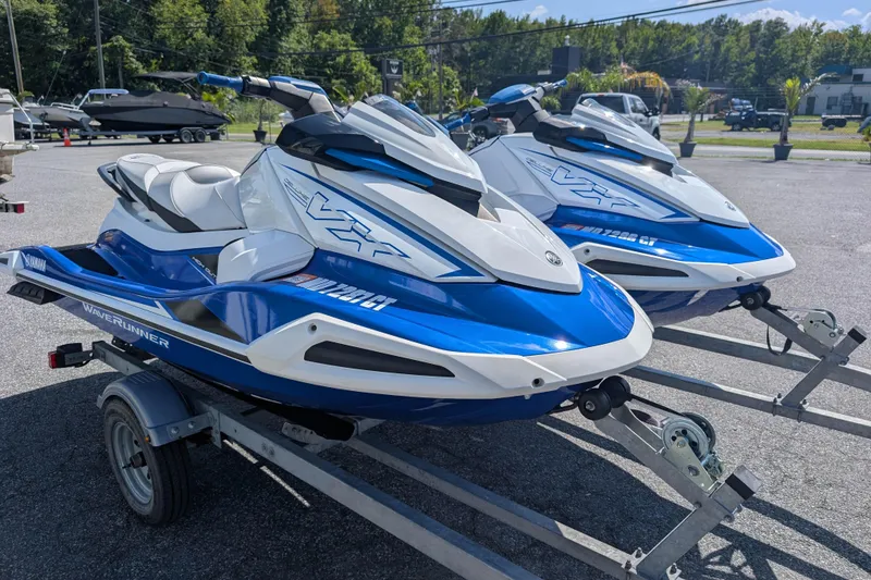 Slide: The Image of 2021 Yamaha WaveRunner VX Deluxe jet skis on trailers, parked outdoors. - 6