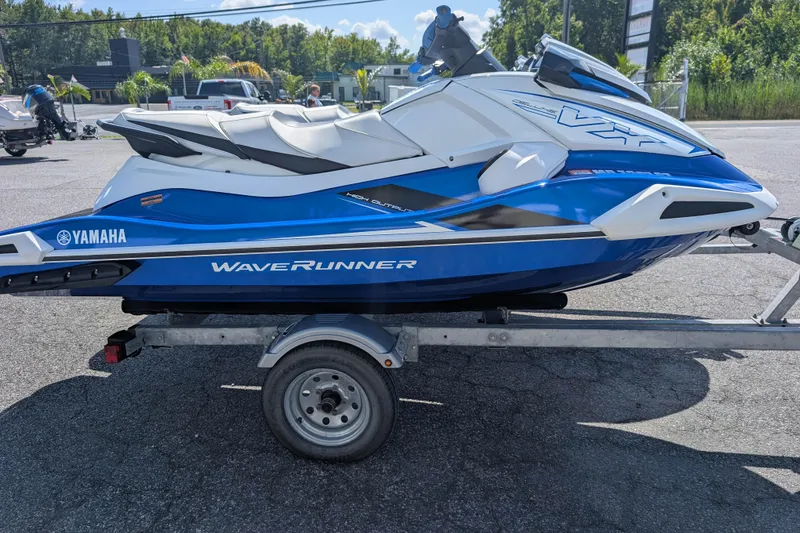 Slide: The Image of 2021 Yamaha WaveRunner VX Deluxe in blue on a trailer, parked outdoors. - 7