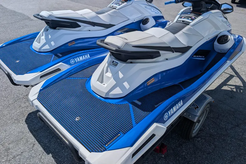 Slide: The Image of 2021 Yamaha WaveRunner VX Deluxe jet skis on a trailer, blue and white design. - 8