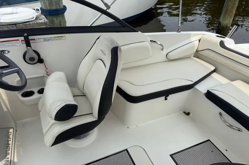 Slide: The Image of 2020 Stingray 192 SC boat interior with white seating and steering wheel. - 12