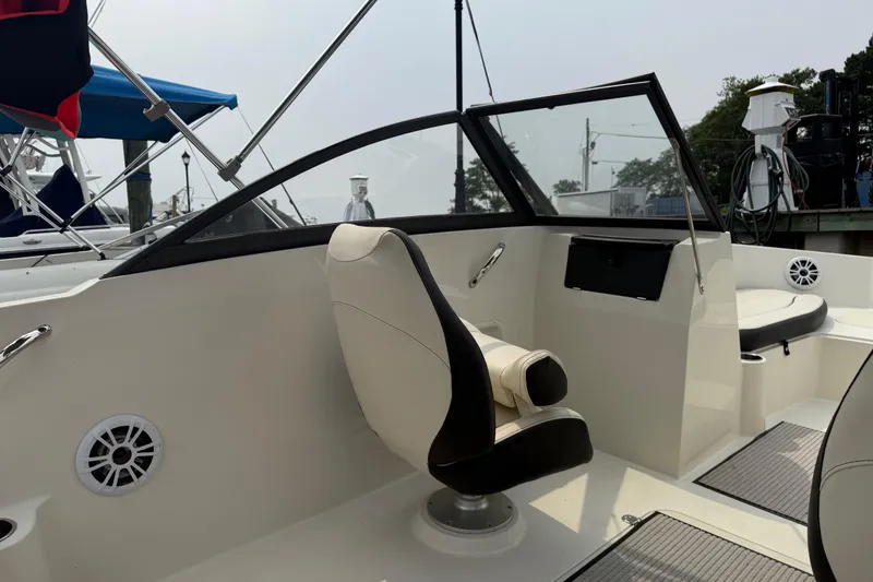 Slide: The Image of 2020 Stingray 192 SC boat interior with seating and dashboard view. - 13