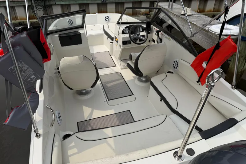 Slide: The Image of 2020 Stingray 192 SC boat interior with seating, steering wheel, and life jackets. - 3