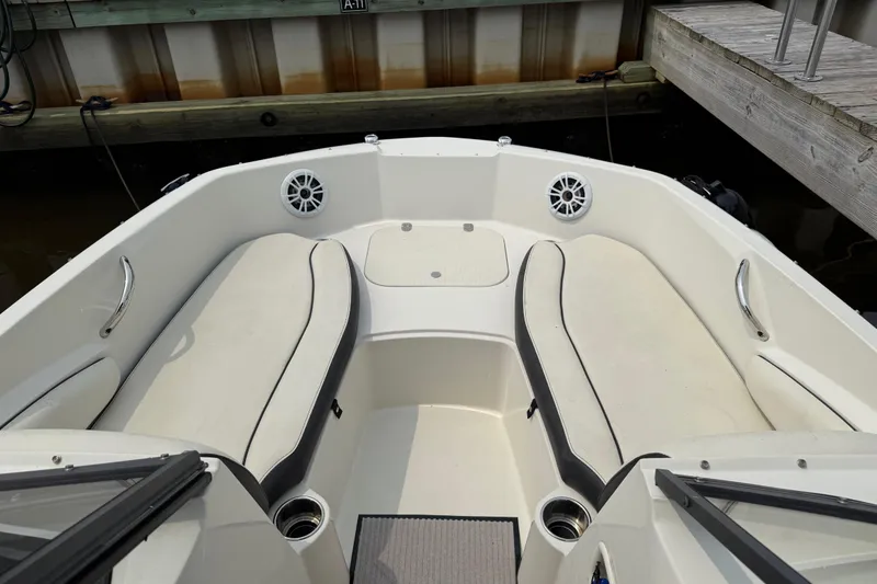 Slide: The Image of 2020 Stingray 192 SC boat interior with cushioned seating and cup holders. - 4