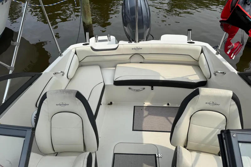 Slide: The Image of 2020 Stingray 192 SC boat interior with white seating and black accents. - 6