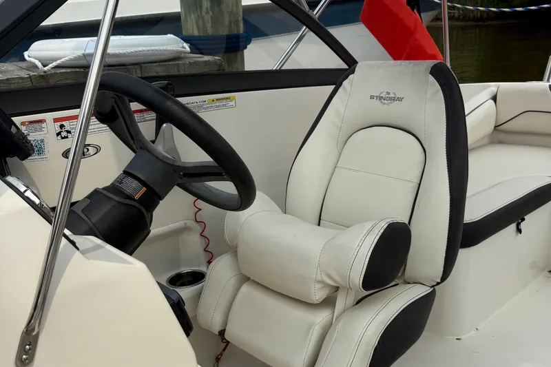 Slide: The Image of Captain's seat and steering wheel of a 2020 Stingray 192 SC boat. - 7