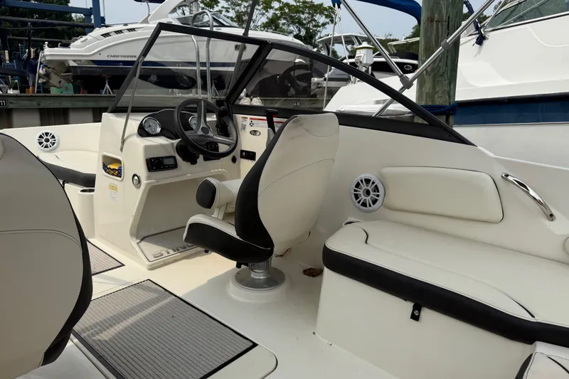 Slide: The Image of 2020 Stingray 192 SC boat interior with steering wheel and seating area. - 8
