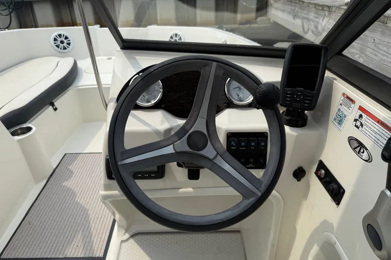 Slide: The Image of 2020 Stingray 192 SC boat dashboard with steering wheel and navigation system. - 9
