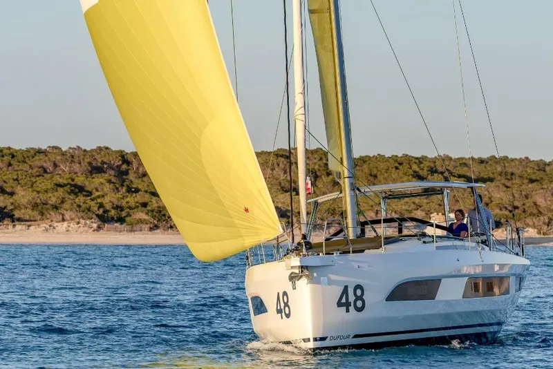 Slide: The Image of Sailing yacht Dufour 48, 2026 model, with yellow sail on open water. - 18