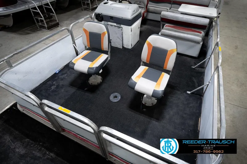 Slide: The Image of 1993 Godfrey Sweetwater pontoon boat interior with two swivel seats and control console. - 11