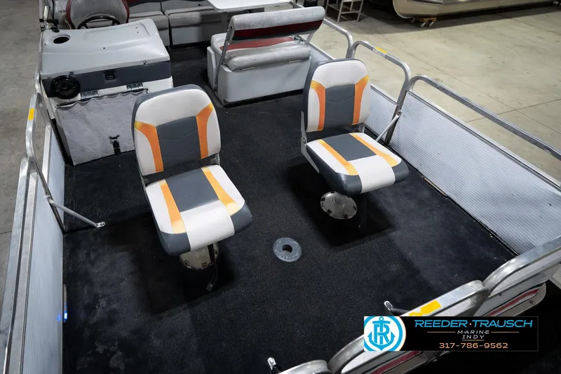 Slide: The Image of 1993 Godfrey Sweetwater boat interior with two swivel seats and carpeted floor. - 12