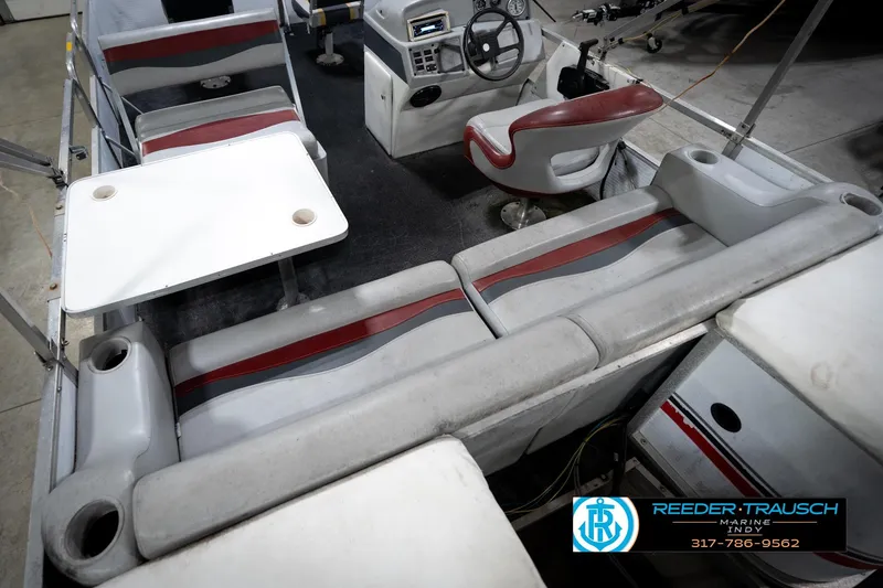 Slide: The Image of Interior of a 1993 Godfrey Sweetwater boat with seating and steering console. - 14