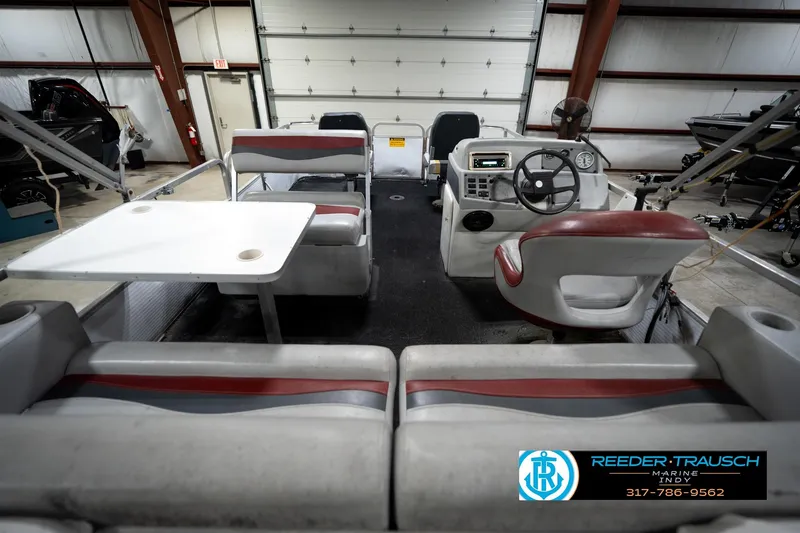 Slide: The Image of 1993 Godfrey Sweetwater pontoon boat interior with seating and steering console. - 15