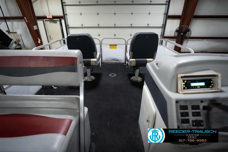Slide: The Image of Interior of a 1993 Godfrey Sweetwater boat with seating and control panel. - 16