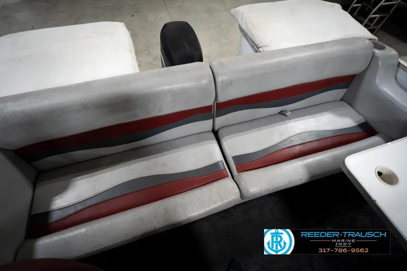 Slide: The Image of 1993 Godfrey Sweetwater boat interior with red and gray seating, Reeder Trausch Marine logo. - 21
