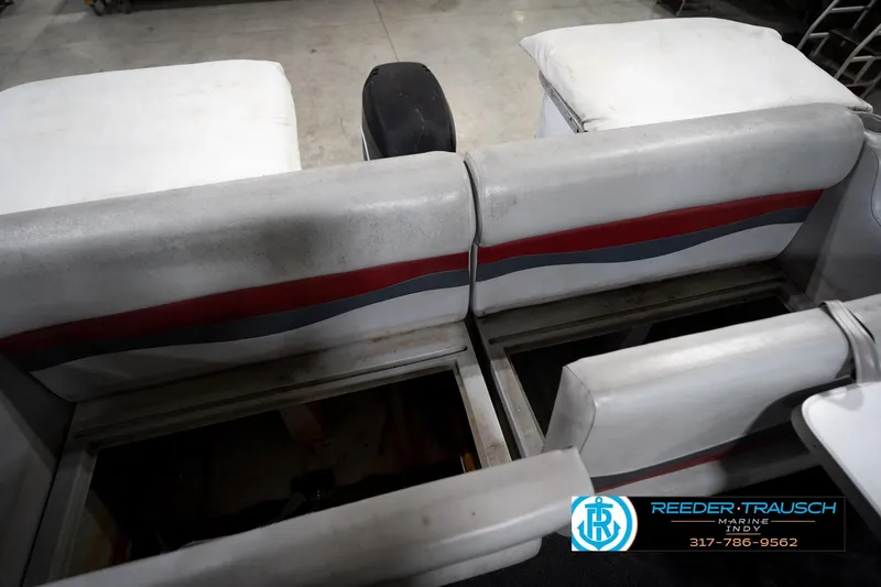 Slide: The Image of 1993 Godfrey Sweetwater boat interior with red and gray seating, Reeder-Trausch Marine logo visible. - 22