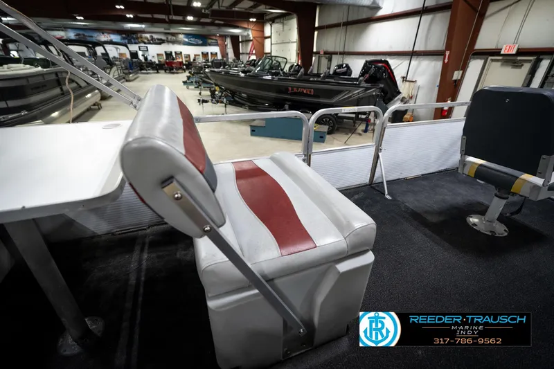 Slide: The Image of 1993 Godfrey Sweetwater boat interior with red and white seating in showroom. - 24