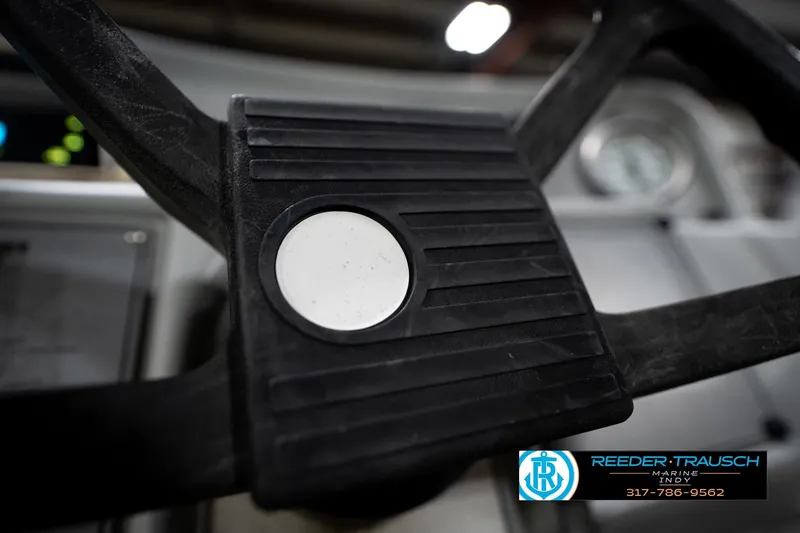 Slide: The Image of Steering wheel of a 1993 Godfrey Sweetwater boat, featuring Reeder-Trausch Marine logo. - 31