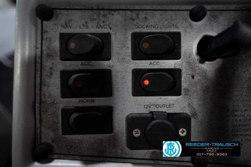Slide: The Image of Control panel of a 1993 Godfrey Sweetwater boat with switches and 12V outlet. - 32