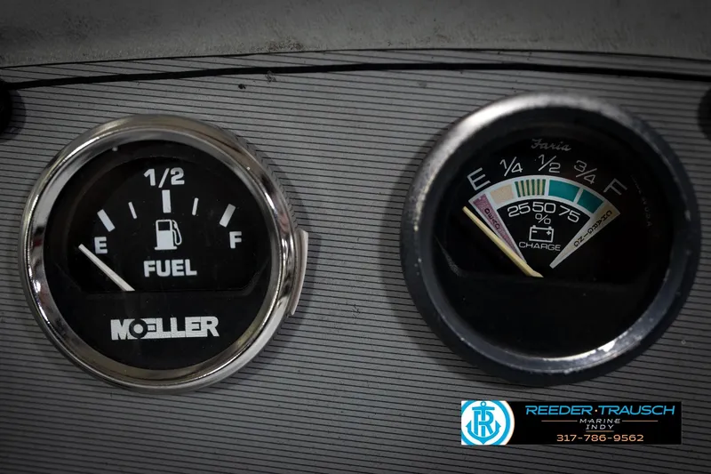 Slide: The Image of Close-up of 1993 Godfrey Sweetwater fuel and charge gauges on a dashboard. - 34