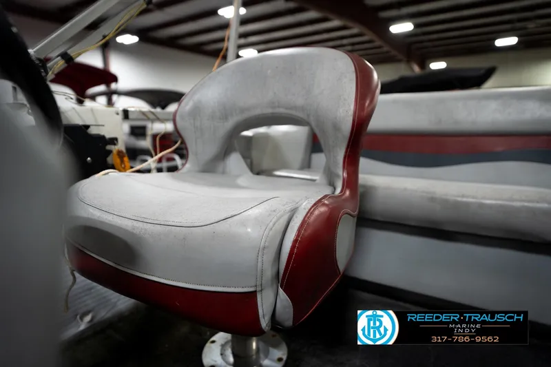 Slide: The Image of 1993 Godfrey Sweetwater boat seat with red and white upholstery in a showroom. - 37
