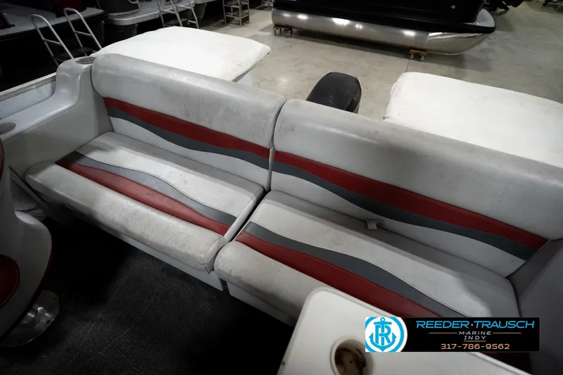 Slide: The Image of 1993 Godfrey Sweetwater boat interior with red and gray seating, Reeder-Trausch Marine logo. - 38