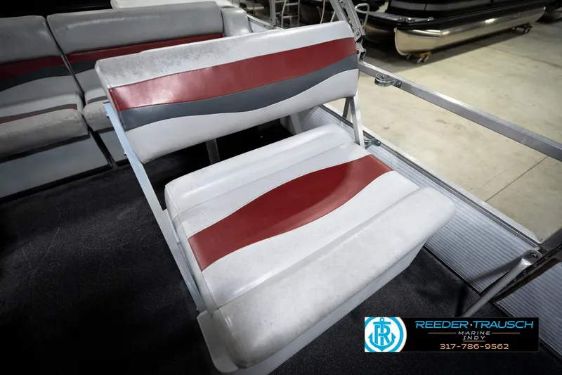 Slide: The Image of 1993 Godfrey Sweetwater boat seat with red and gray stripes, showcased indoors. - 39