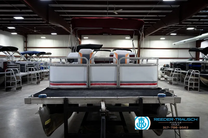 Slide: The Image of 1993 Godfrey Sweetwater pontoon boat in indoor showroom, Reeder-Trausch Marine. - 4