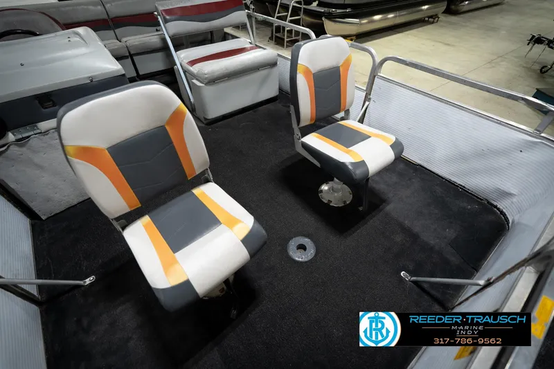Slide: The Image of 1993 Godfrey Sweetwater boat interior with two swivel seats and carpeted floor. - 40
