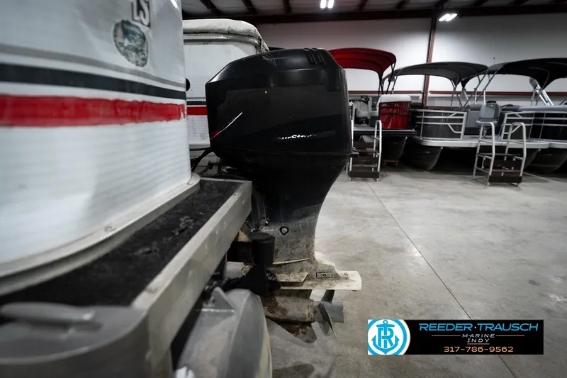Slide: The Image of 1993 Godfrey Sweetwater boat with outboard motor in a showroom. - 45