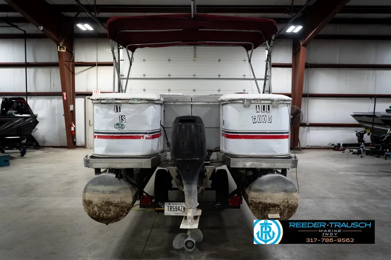 Slide: The Image of 1993 Godfrey Sweetwater pontoon boat in a garage, rear view with canopy. - 8
