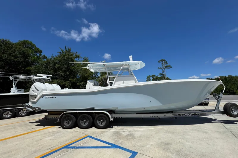 Slide: The Image of 2021 Invincible 36 Open Fisherman boat on trailer under clear blue sky. - 10