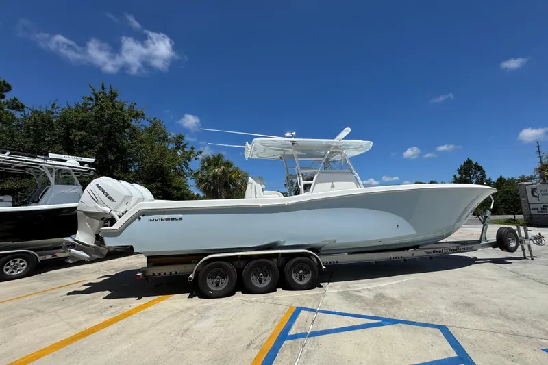 Slide: The Image of 2021 Invincible 36 Open Fisherman boat on trailer under clear blue sky. - 11