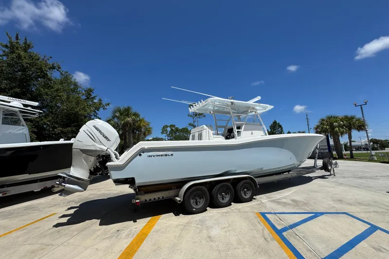 Slide: The Image of 2021 Invincible 36 Open Fisherman boat on trailer under clear blue sky. - 12
