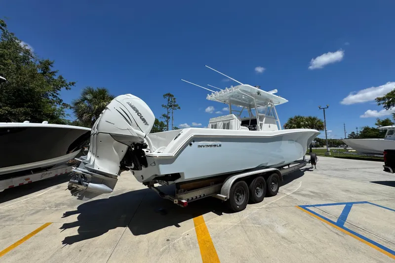 Slide: The Image of 2021 Invincible 36 Open Fisherman boat on trailer under clear blue sky. - 13