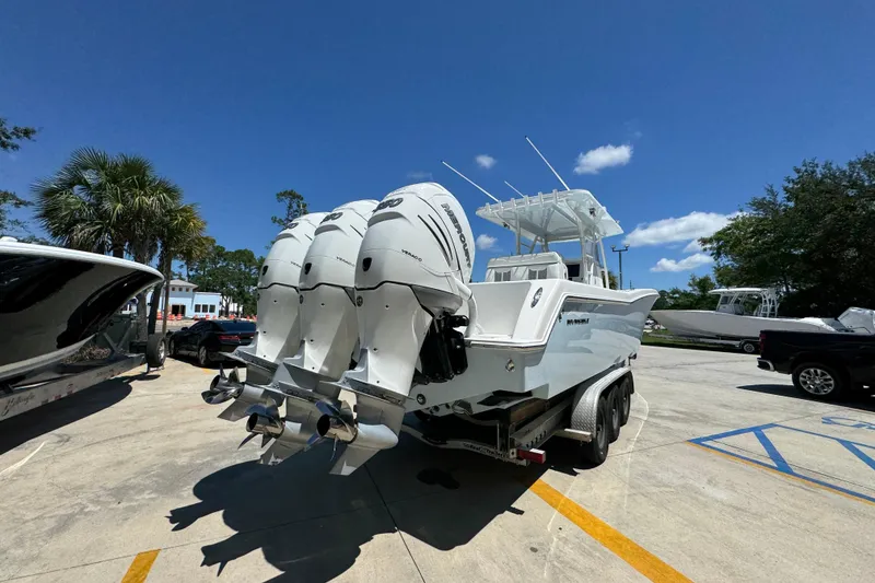 Slide: The Image of 2021 Invincible 36 Open Fisherman boat with triple outboard engines on a trailer. - 14